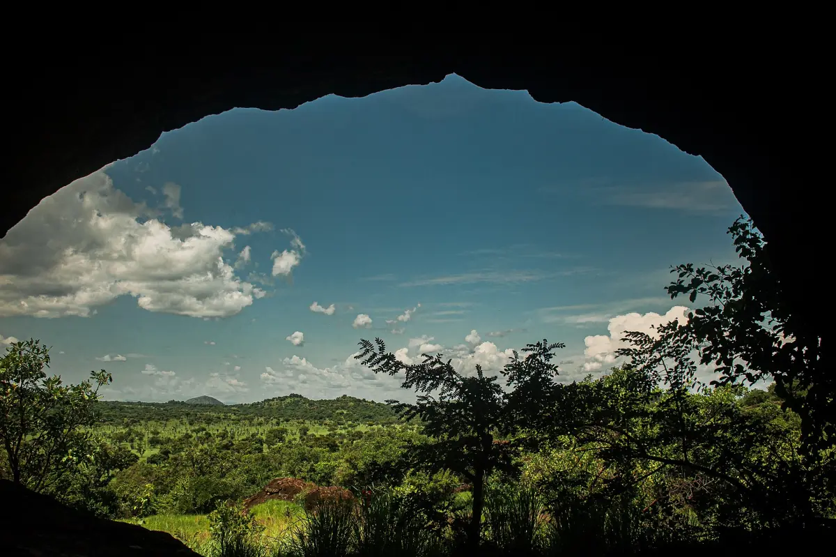 View over Karamoja hills framed by the opening of a rock cave